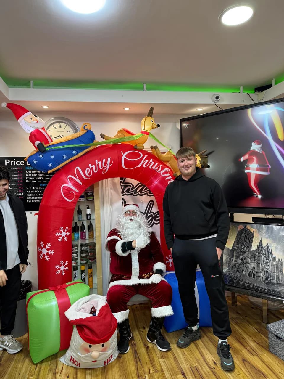 A customer with Santa under the Christmas arch in the shop