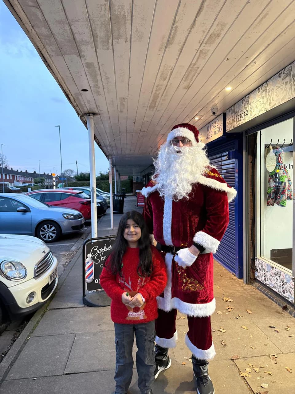 Santa on the parade outside the shop during the Christmas giveaway